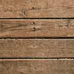 Close-up of natural wooden planks showcasing unique grain and texture, perfect as a background.